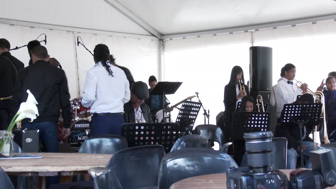 A jazz band tune their instruments before an open air concert