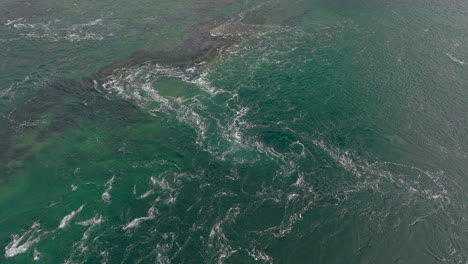 aerial view of swirling ocean waves in northern norway