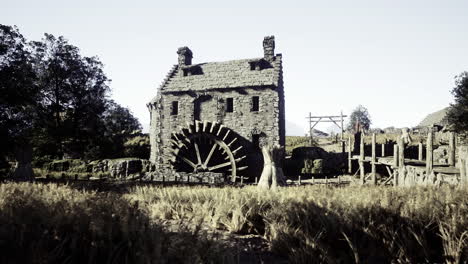 historic watermill surrounded by fields in a rural landscape during daylight