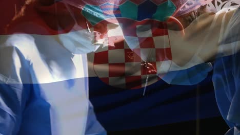 animation of flag of croatia over surgeons in operating theatre