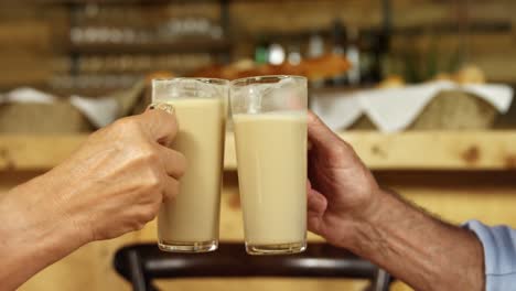 Senior-couple-toasting-coffee-glasses-in-the-cafe-4k