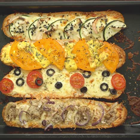 Delicious-hot-sandwich-baguettes-baked-with-tuna--cheese--tomatoes--olives--courgette-and-mushrooms