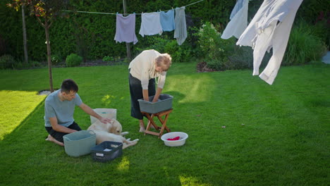 family washing clothes outdoors