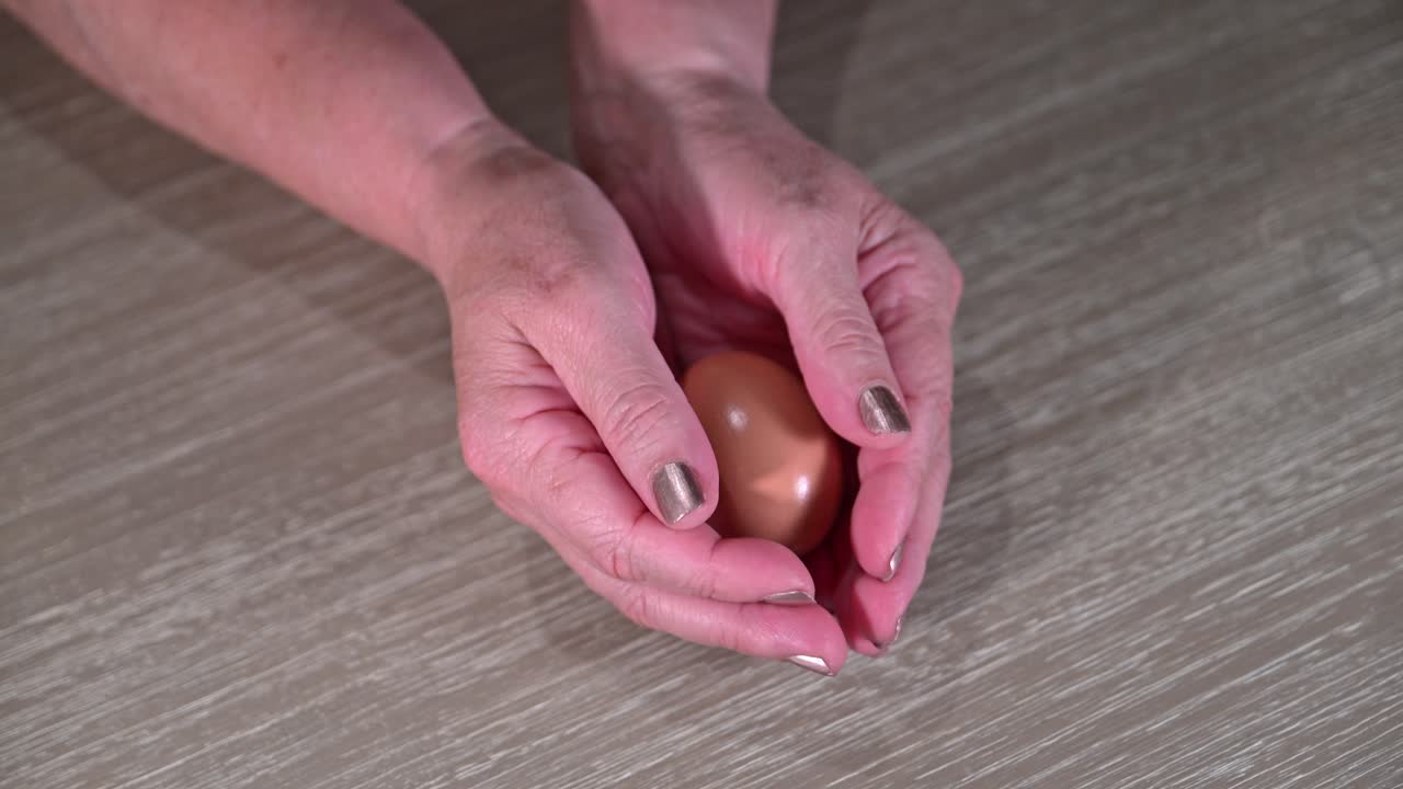 elderly female hands open to reveal a retirement nest egg