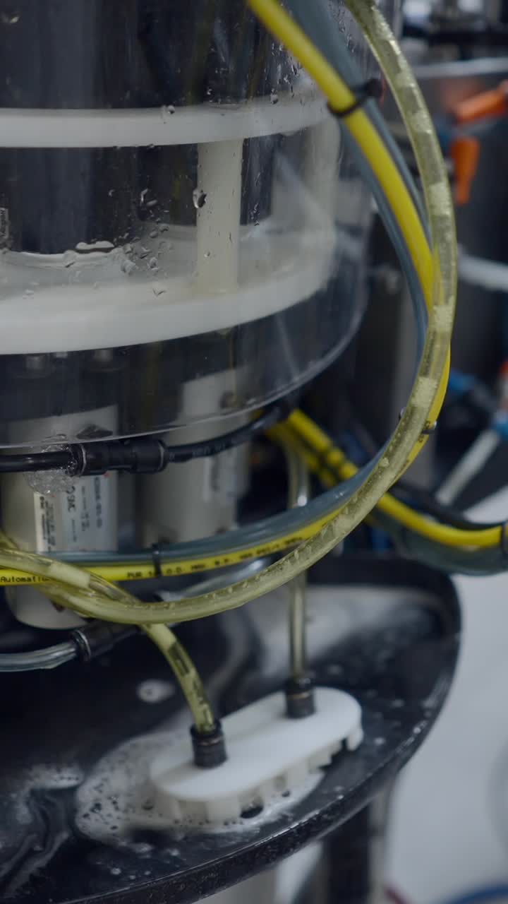 Close-up of Industrial or Laboratory Equipment with Tubing and Liquid