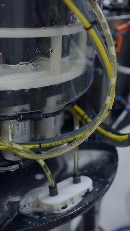 Close-up of Industrial or Laboratory Equipment with Tubing and Liquid