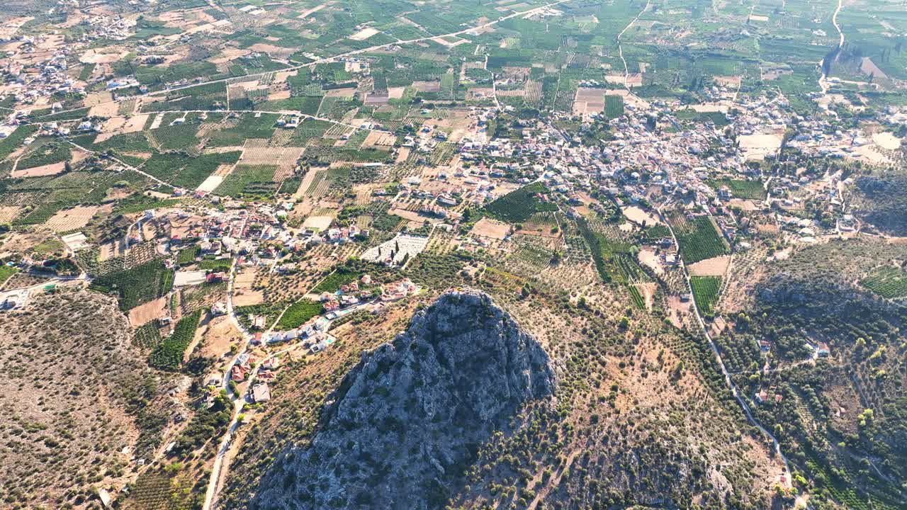 Drone flight over agricultural land and a hill