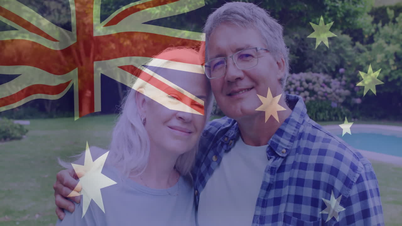 Holding Australian flag, smiling couple in garden with animation overlay outdoors