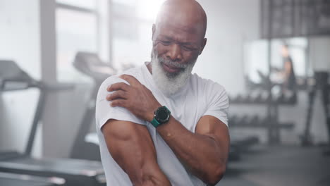 senior man with shoulder pain at the gym