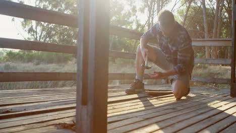 man removing hardwood floors of cabin porch 4k