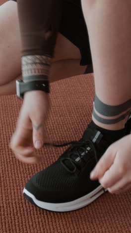 person tying shoelaces before workout