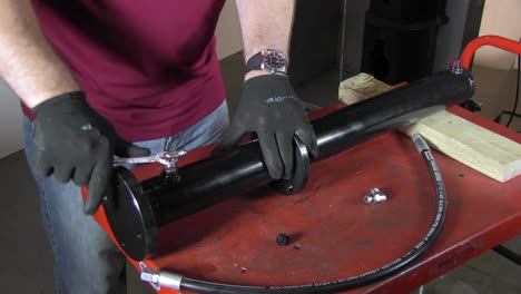 installing valve on paint mixer pipe using a crescent wrench
