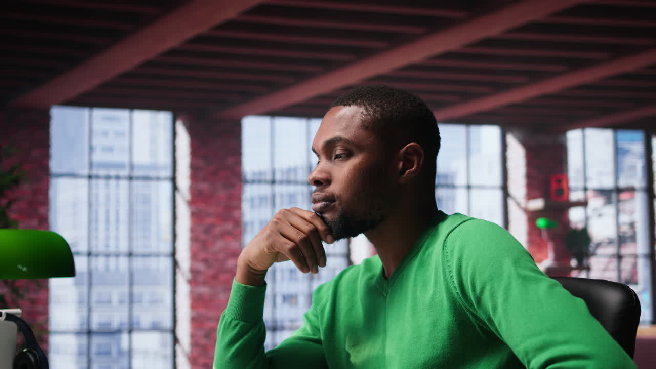 Vertical Video Black teleworker being pensive thinking about solutions to make more money