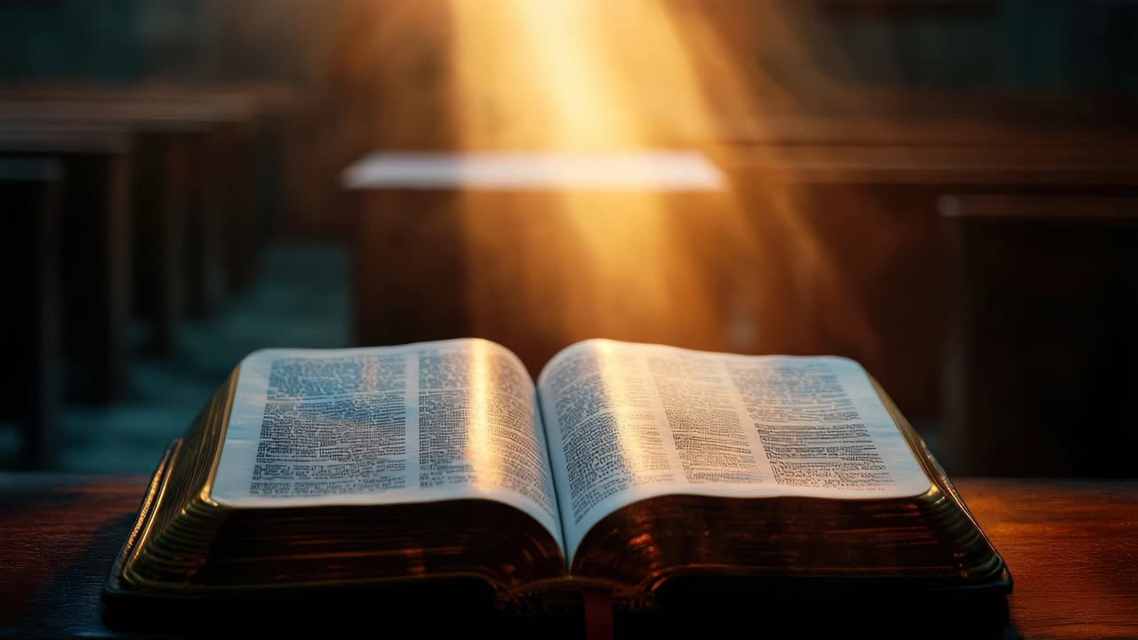A warm, cinematic video scene of an open book on a wooden table, captured from a low angle