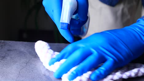 cleaning a counter with spray bottle and cloth