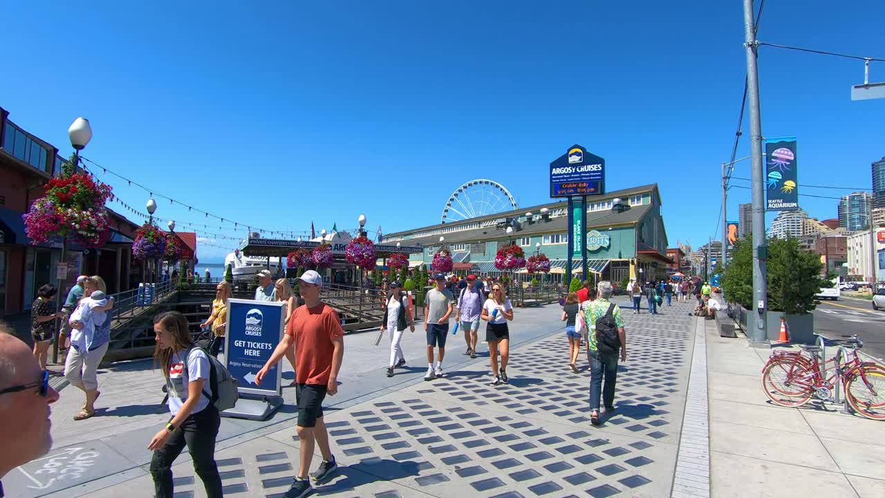 Tourists walk on street of Seattle city, sunny summer holiday day, Washington state, West coast of the United States of America