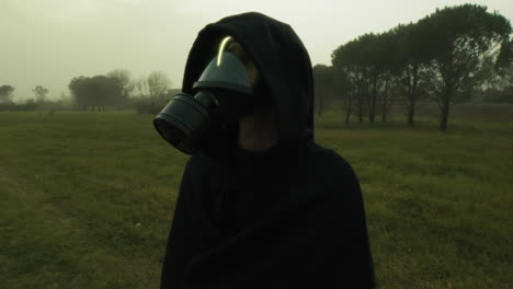 man in radiation mask observes post apocalyptic environment