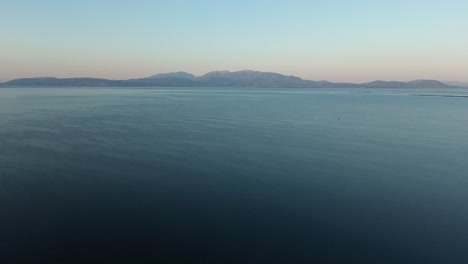 Wide-ocean-view-panorama-with-mountainous-coastline-on-the-horizon