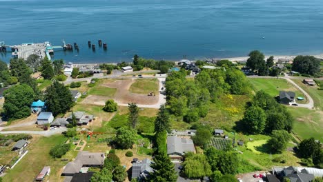 Aerial-shot-over-top-of-rural-community-on-Whidbey-Island-with-a-ferry-dock-in-the-background