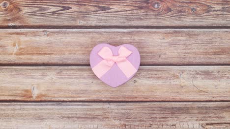 blue and pink pastel colored presents with bows changing on wooden table - stop motion