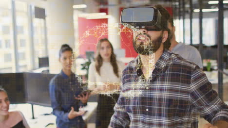 wearing vr headset, man experiencing animation while colleagues discussing in office