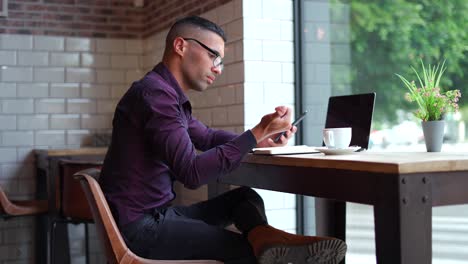 young business man working with his laptop in a restaurant