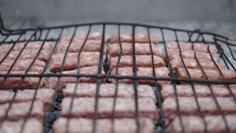 raw meat sausages grilling on a barbecue