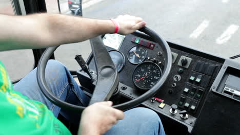 Shot-of-the-dashboard-and-steering-wheel-of-a-bus-while-driving