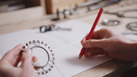 close up of engineer in workshop measuring components for bicycle with micrometer