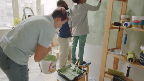 family painting the walls