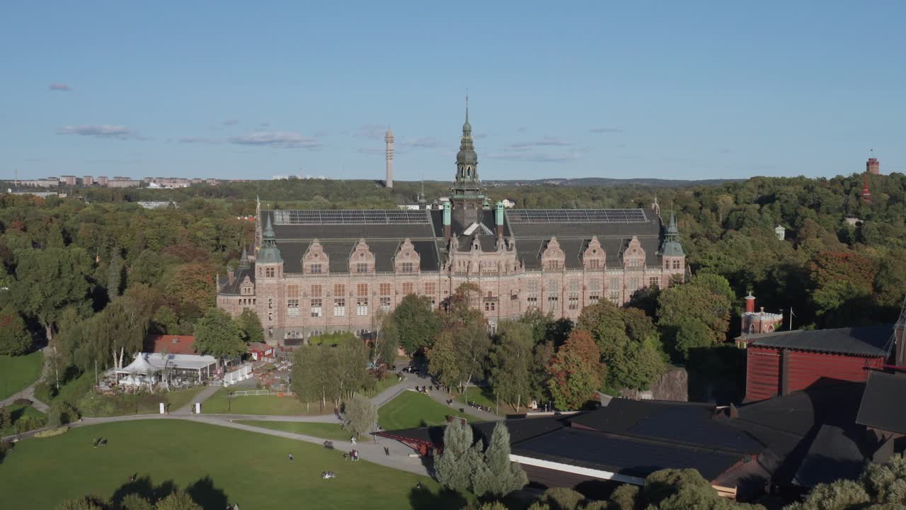 Wide aerial view of Nordiska Museet with Kakn&auml;stornet and forest in background on sunny evening on Djurg&aring;rden in Stockholm, Sweden
