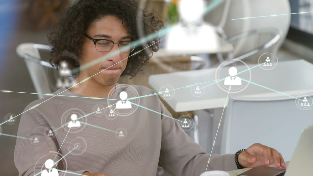 Animation of network of connections with people icons over biracial businessman using smartphone