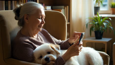 elderly woman and her pet dog relaxing at home with a smartphone