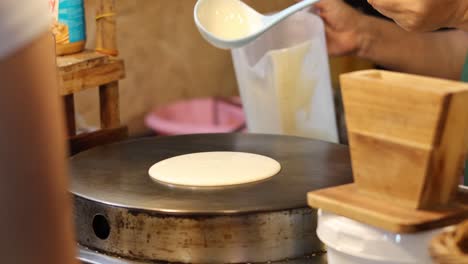 crepe preparation process at a bustling market