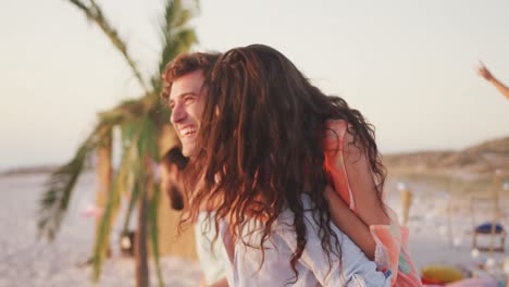 Caucasian-couple-enjoying-a-party-on-the-beach-