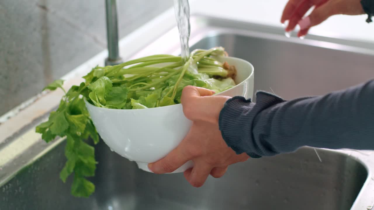 Washing vegetables in a kitchen sink