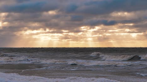 sea storm with big waves at sunset