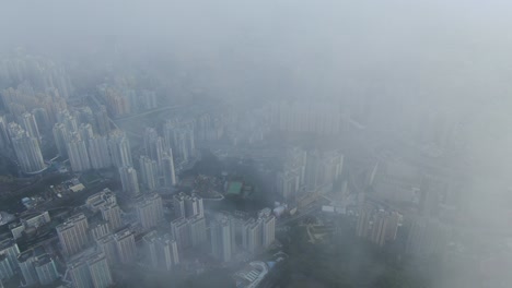 hong kong bay and skyline with skyscrapers, high altitude wide shot with early morning mist