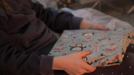 closeup of angry or very excited child open a gift for birthday or christmas