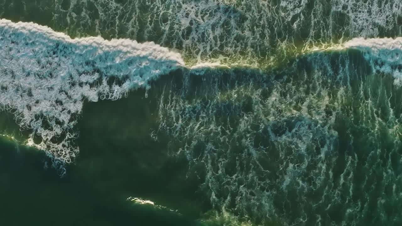 Waves roll towards the shore in California during a sunny day