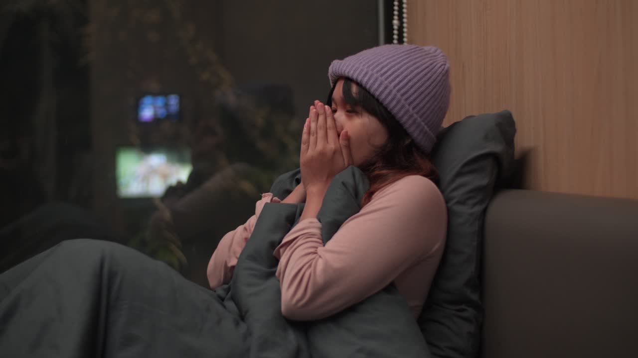 Indonesian young girl feeling cold in a glass room