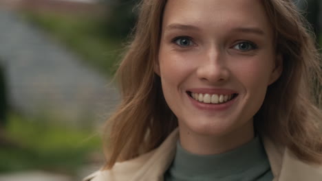 Caucasian-woman-looking-at-the-camera-and-smiling-outdoors.