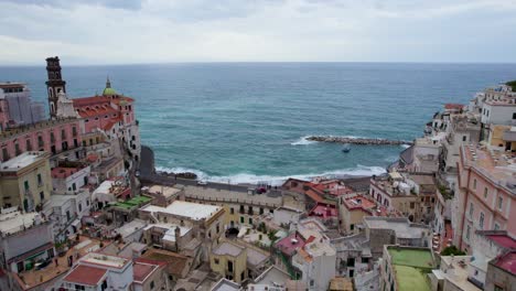 flight over centre of cliffside town looking out over tyrrhenian sea, amalfi