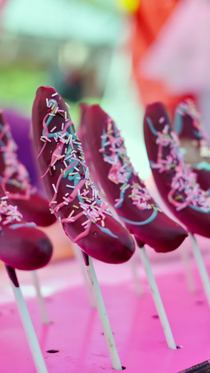 Chocolate covered bananas at a street food market in Japan. Vertical