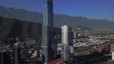 Aerial-jib-up-of-a-big-skyscraper-in-San-Pedro,-Nuevo-Leon,-Mexico