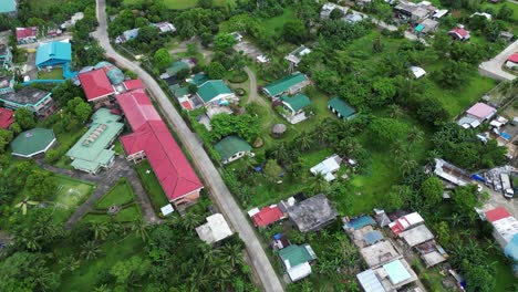 aerial panoramic view of southeast asia neighborhood and school along quiet road