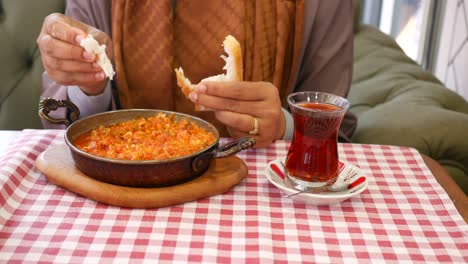 woman eating menemen turkish breakfast