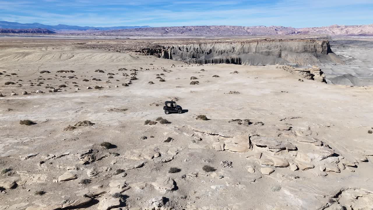 Drone Shot of UTV Vehicle Moving on Top of Mesa With Stunning View of Utah Desert USA