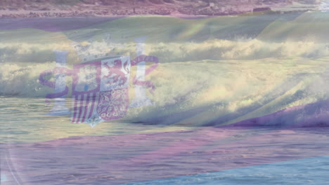 digital composition of spain flag waving against aerial view of waves in the sea