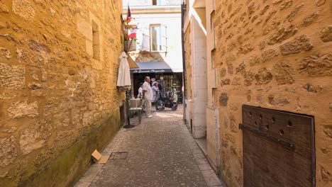 people walking through a narrow, historic alley